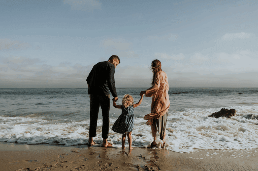 mother father at beach with child