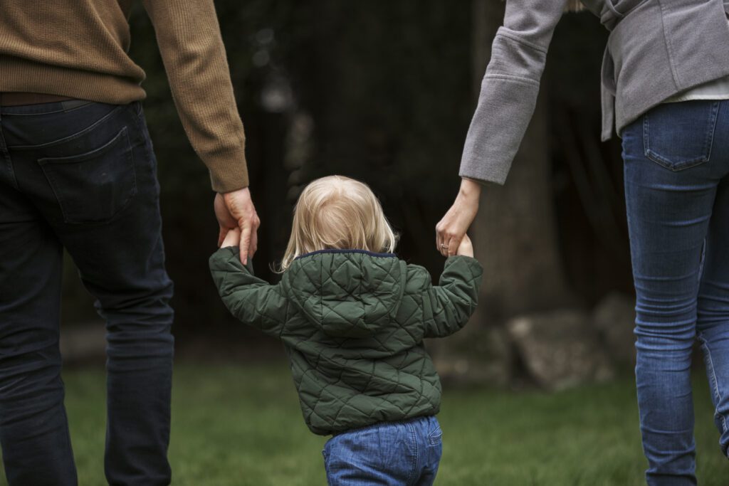 WHat is your parenting style? Parents holidng toddlers hand walking outside